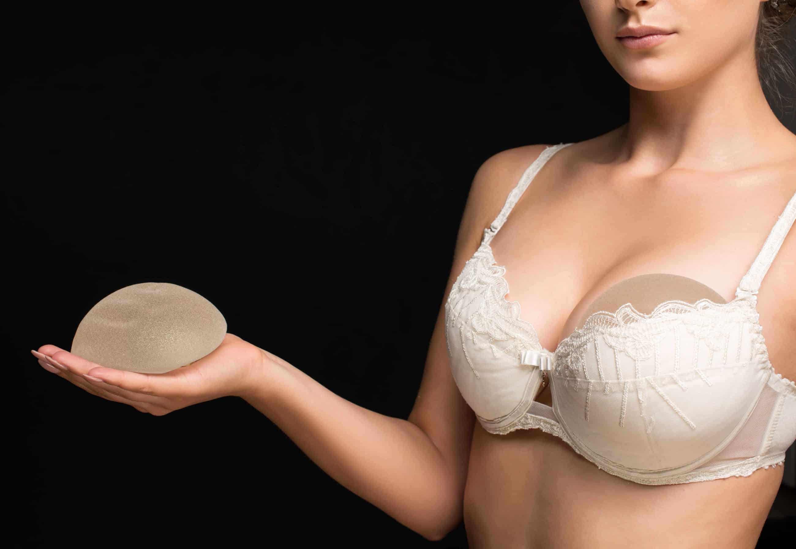 woman holding breast implant